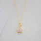 Dainty rose quartz star pendant necklace on a gold chain.