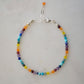 A dainty, beaded, multi-color gemstone bracelet depicting the rainbow, pride, or the chakras. Natural crystals include: turquoise, apatite, emerald, garnet, yellow opal, amethyst, aventurine, and lapis lazuli. Handcrafted in Connecticut by Gemnia Jewelry.