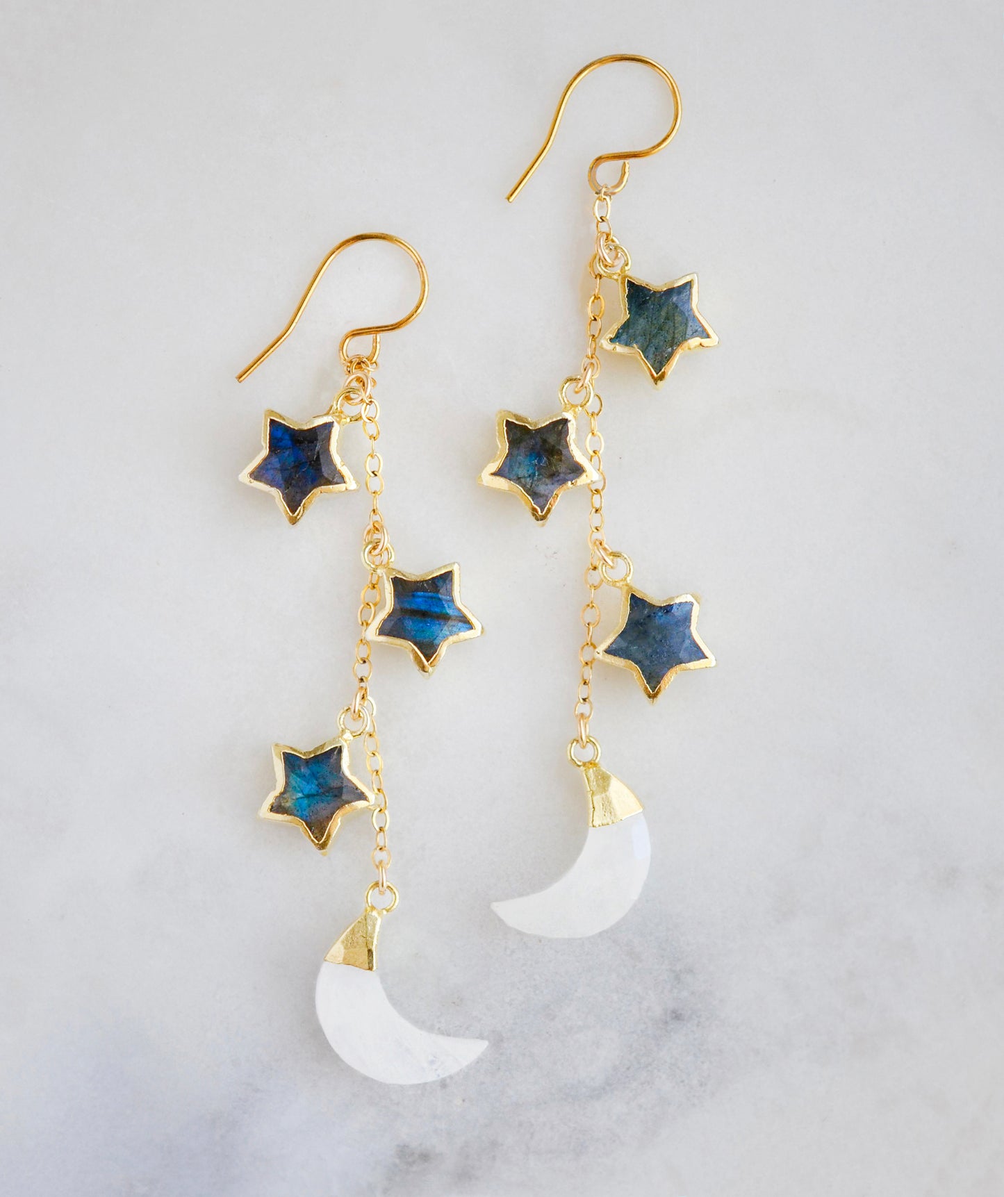 These handmade earrings feature genuine labradorite stars atop rainbow moonstone crescent moons. These dangles are long but lightweight. Shown in gold, but also available in sterling silver.