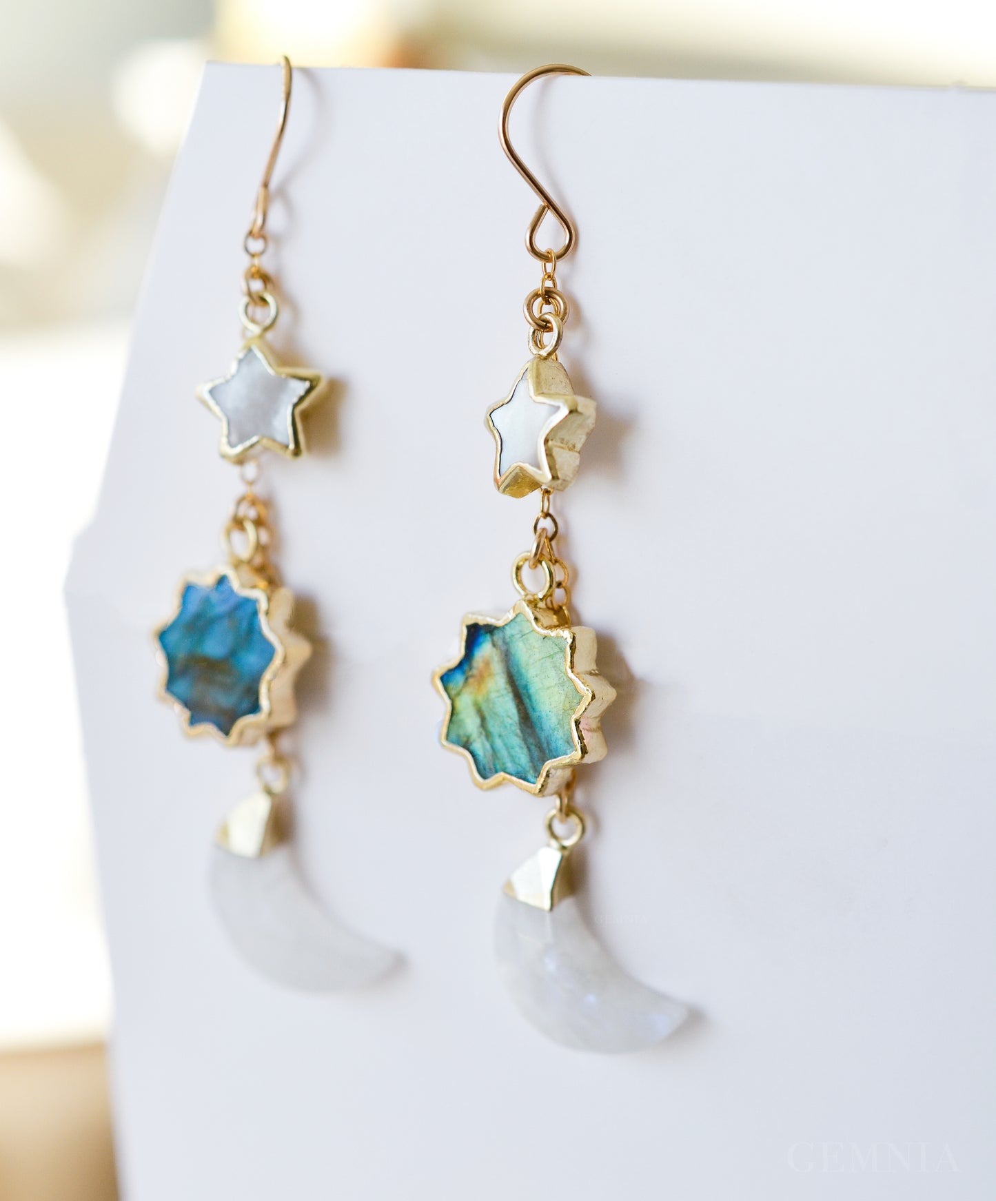 Natural labradorite, mother of pearl, and rainbow moonstone sun, moon, and star celestial earring dangles. Handmade in 14k gold filled. Dainty minimalist gemstone jewelry by Gemnia. 