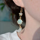 Modeled image of a sun, moon, and star celestial dangle earrings. 