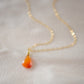 Natural orange triangular shaped Carnelian gemstone set onto a gold chain. Stones vary in color from orange to red.