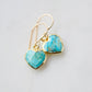 Genuine, natural blue turquoise faceted hearts set on 14k gold filled earring hooks. The stones range in blue and green, with some containing white or brown.