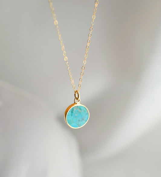 Round aqua blue Turquoise set into a gold bezel and suspended from a 14k gold filled chain.