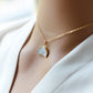 This necklace is handmade with a natural white druzy quartz pendant in a half-circle or crescent shape. Available in 14k gold filled. Modeled image.