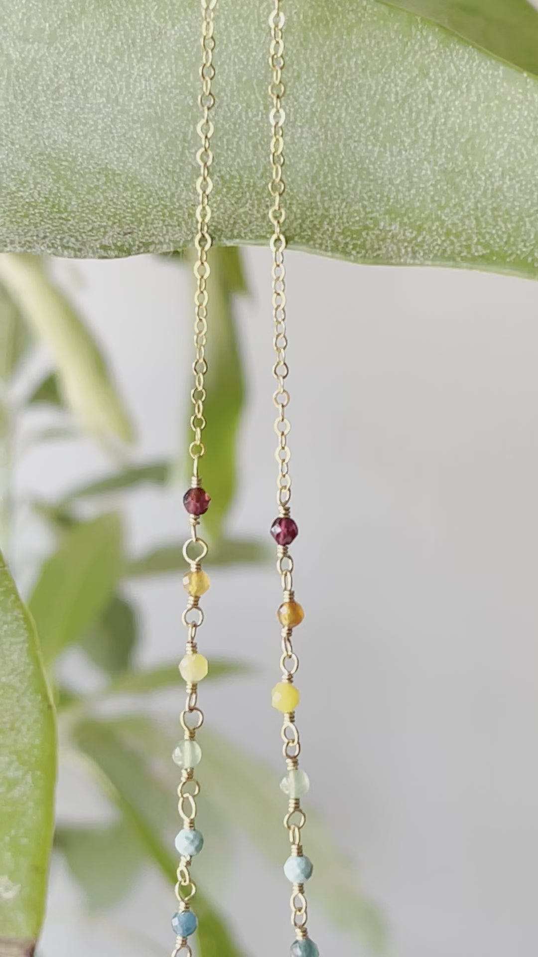 Rainbow, pride, or chakra necklace with tiny gemstones and a white freshwater pearl. The 14k gold filled style is shown. Video