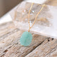 Aqua blue amazonite slice gemstone set onto a beaded 14k gold filled chain. The stone is semi oval in shape, but irregular. It's smooth polished, but with raw edges. 