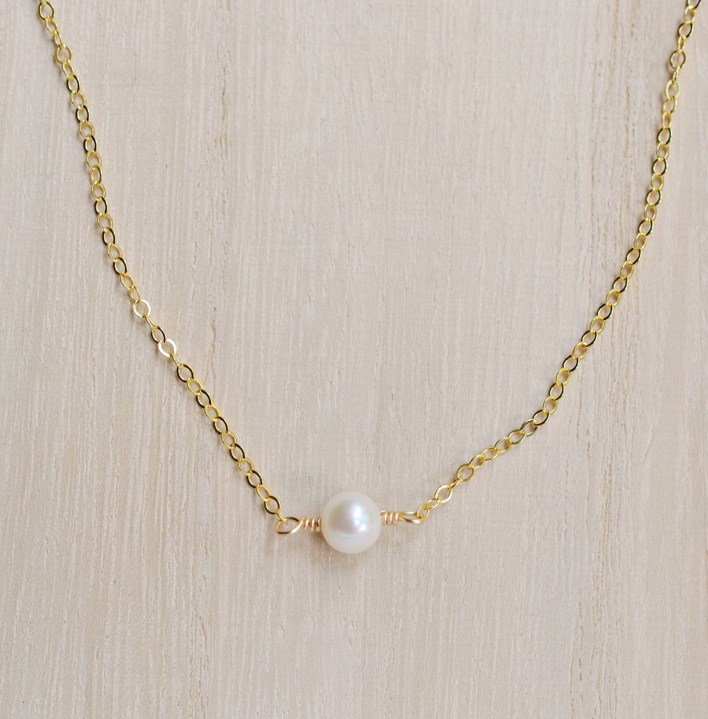 Single round white freshwater pearl necklace on a 14k gold filled chain.