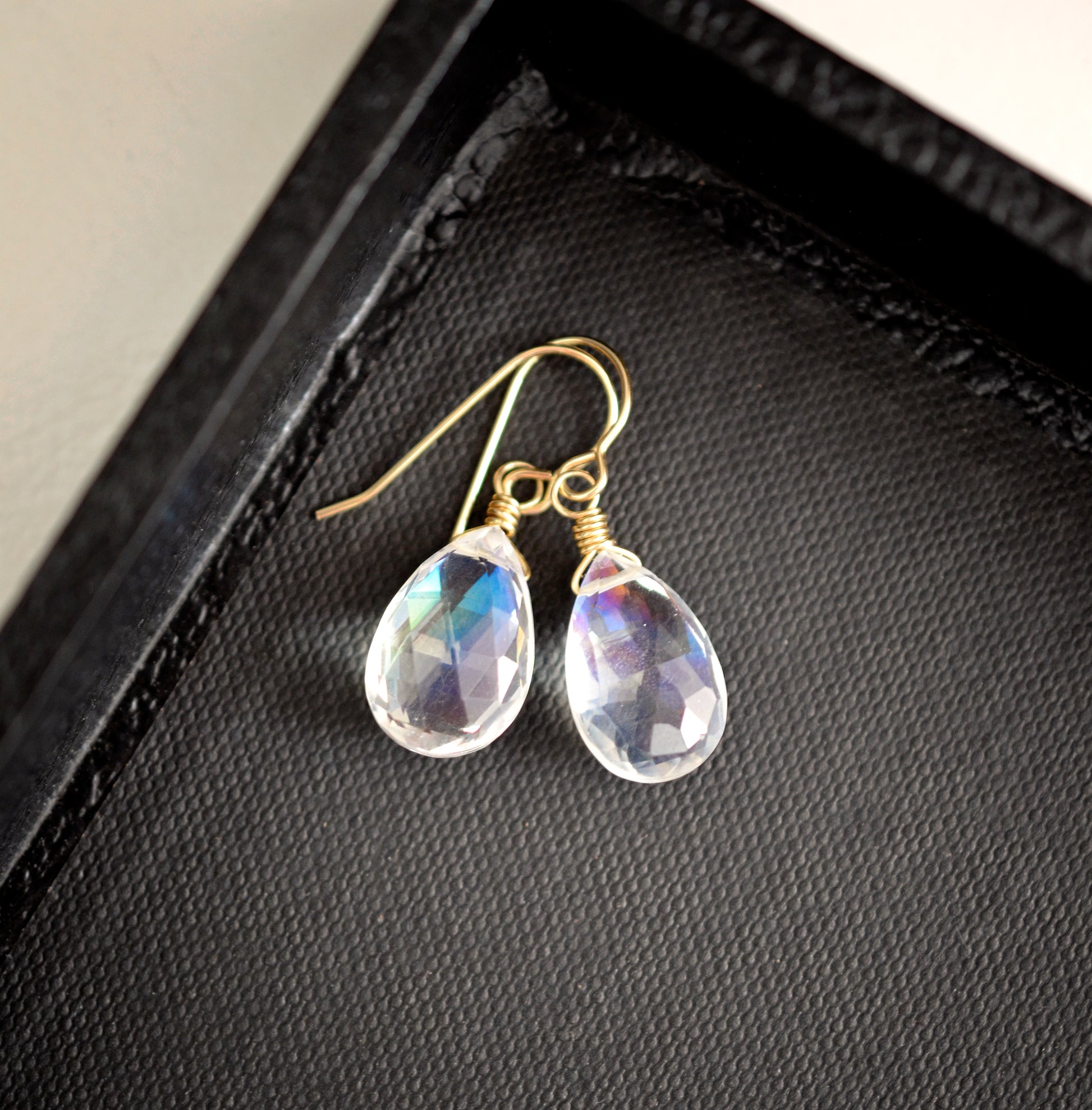 Rainbow colored mystic topaz earrings in 14k gold filled. The stone is a teardrop shape and shifts different rainbow colors..
