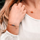 Handmade gemstone bracelet featuring CZ, garnet, amethyst, lapis lazuli, apatite, and emerald crystals arranged on a short bar. Available in gold filled or sterling silver.