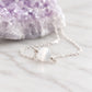 A close up image of a sterling silver necklace with a single stone of natural white selenite. Handmade jewelry in Connecticut by Gemnia.