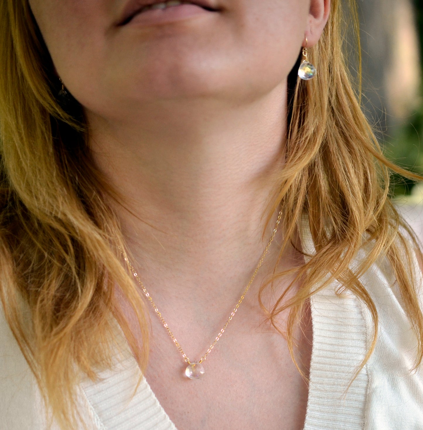 Mystic Topaz teardrop necklace, modeled in 14k gold filled and shown with the matching earrings.